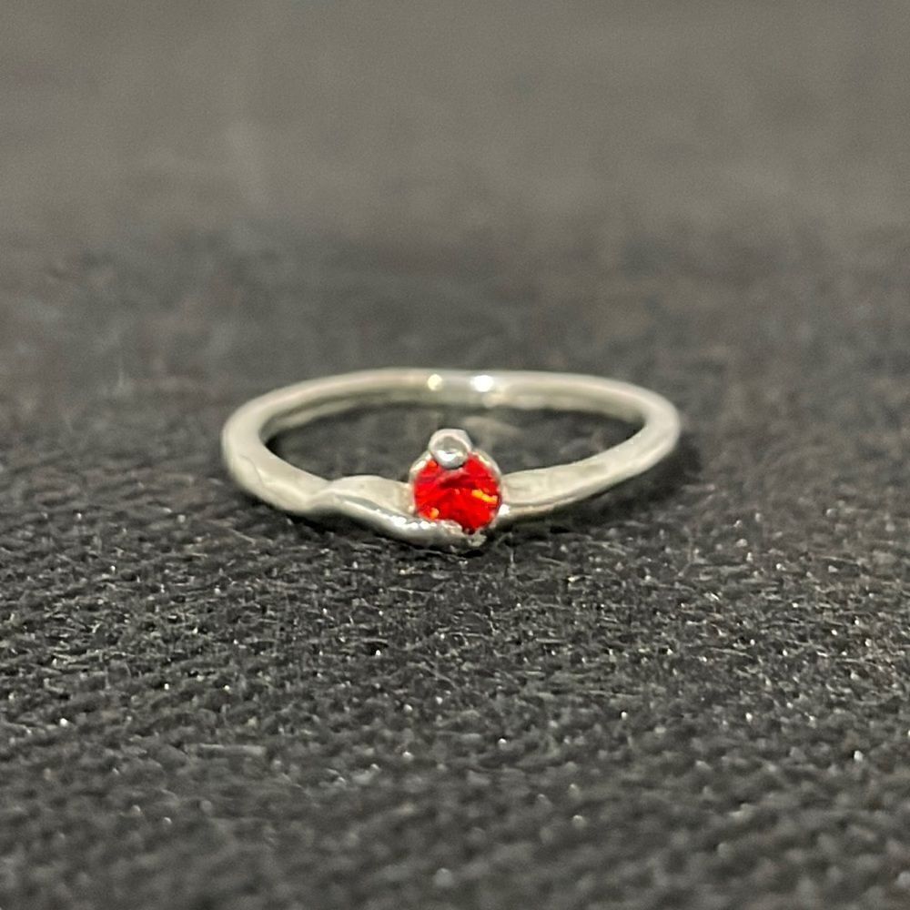 Small thin ring with a small red gem